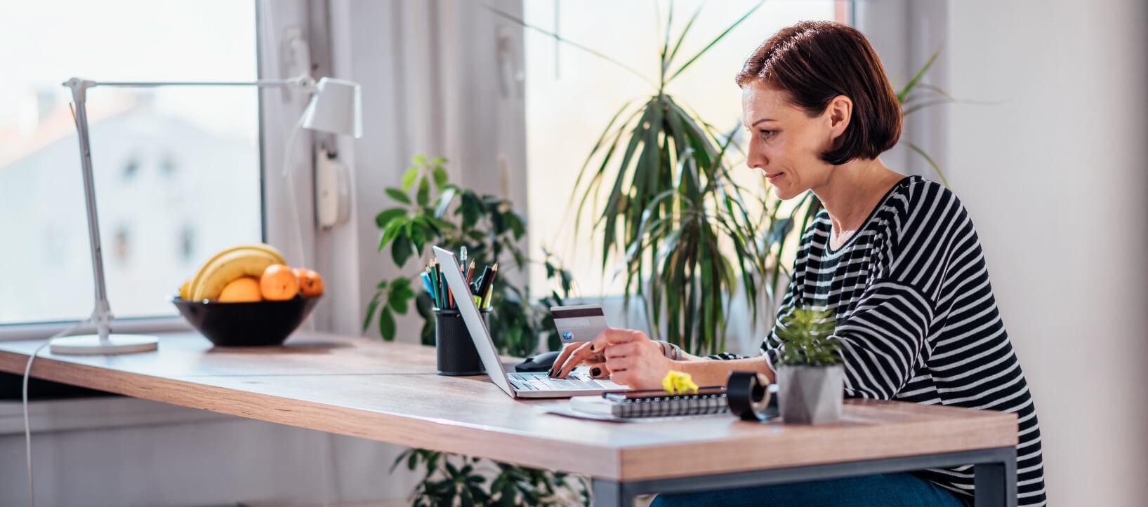 business owner shopping for dental plans on her laptop