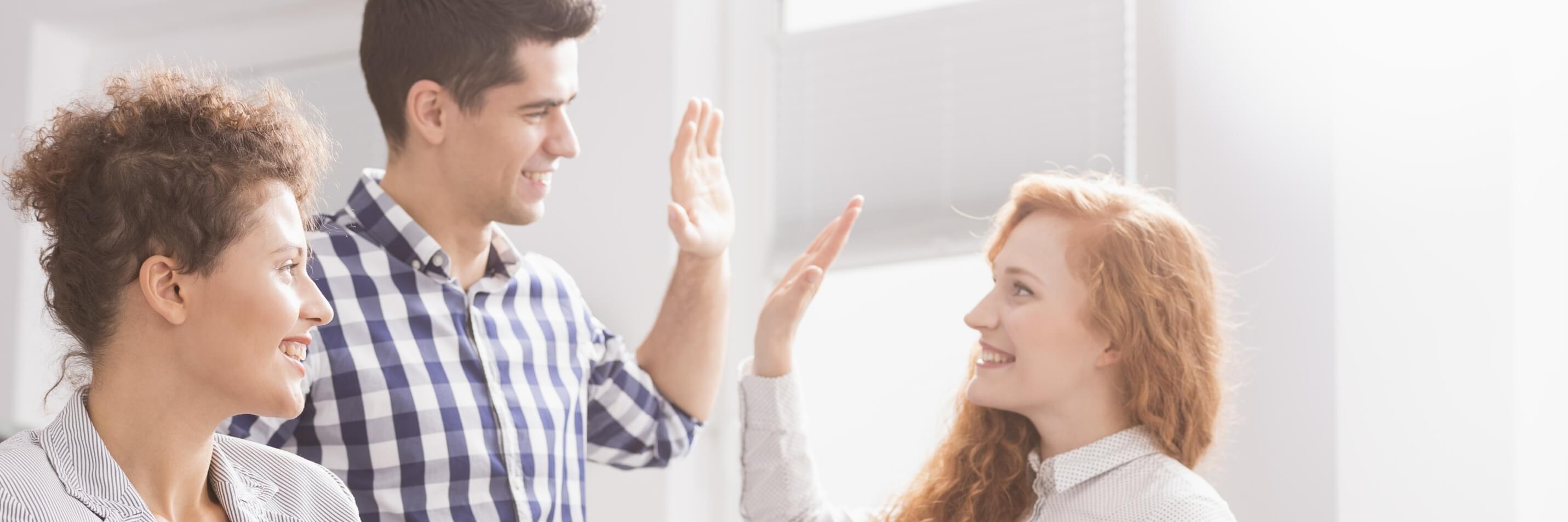 small business meeting. man giving high five to woman