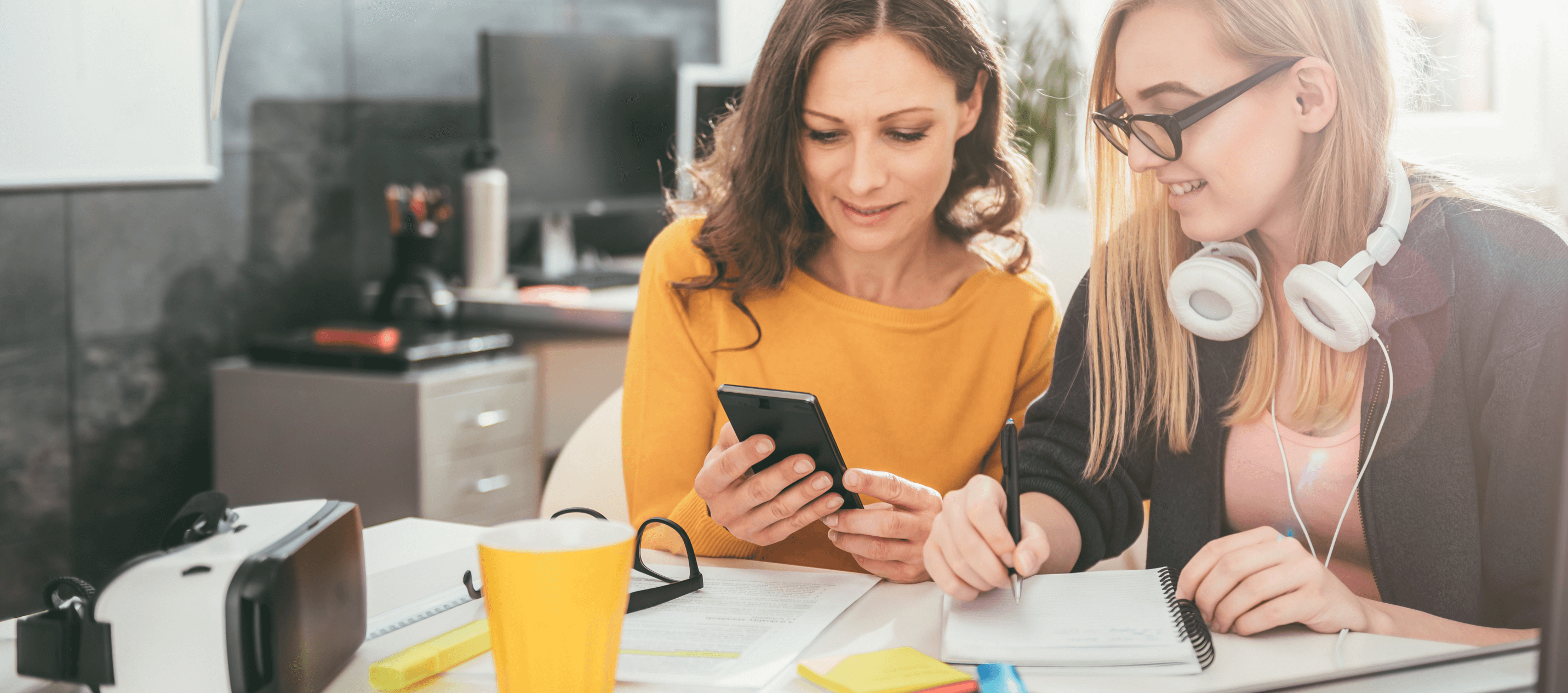 business owner showing dental plans to employee on her phone