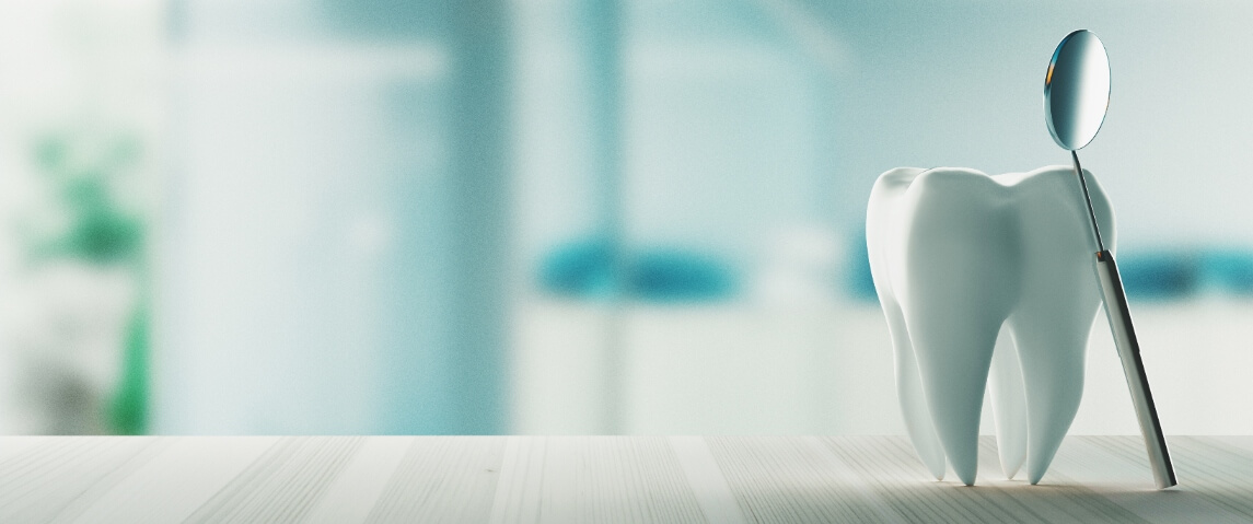 dental mirror leaning against tooth statue