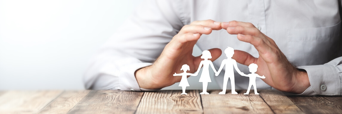 hands above paper cutouts of family