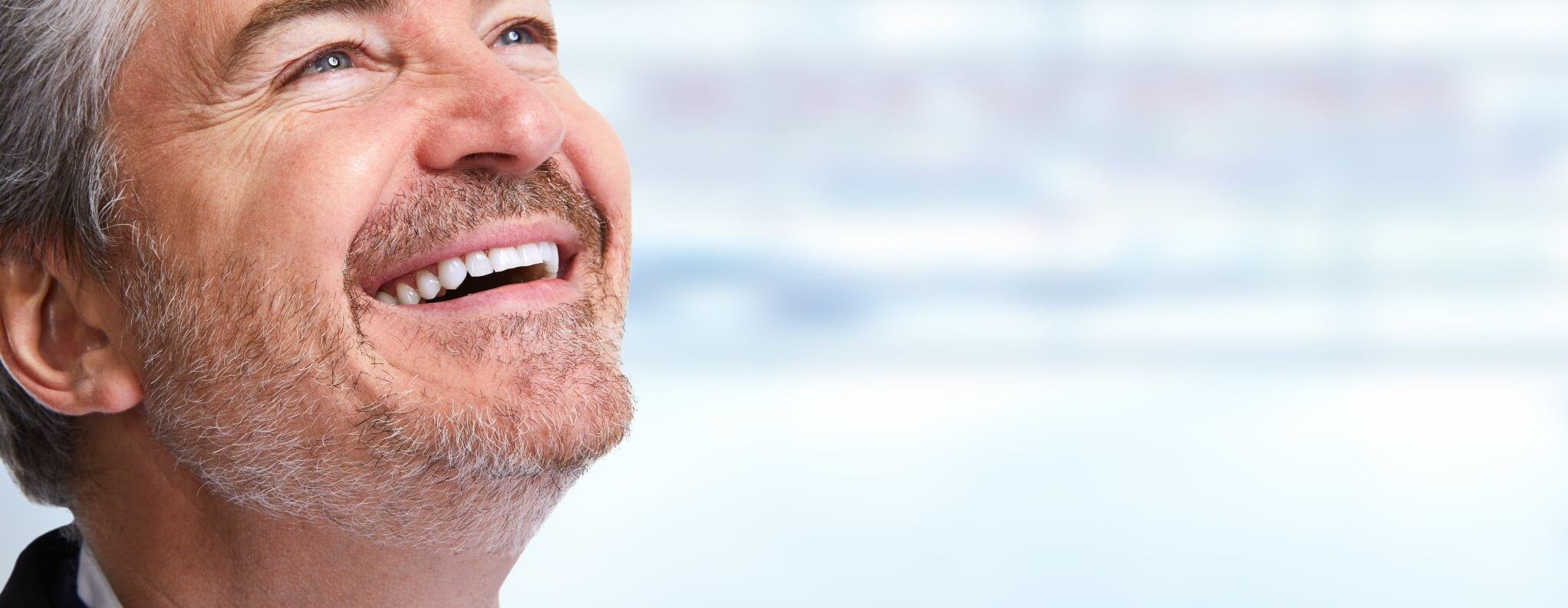 man smiling and looking up