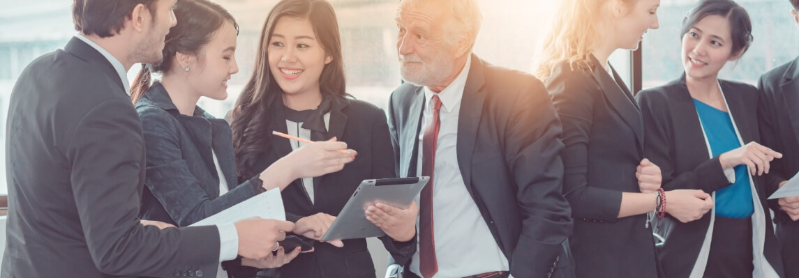 group of business men and women talking about partnerships
